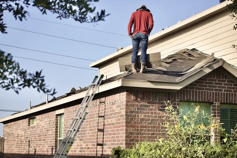 Professional roofer working on a residential roof in Frog